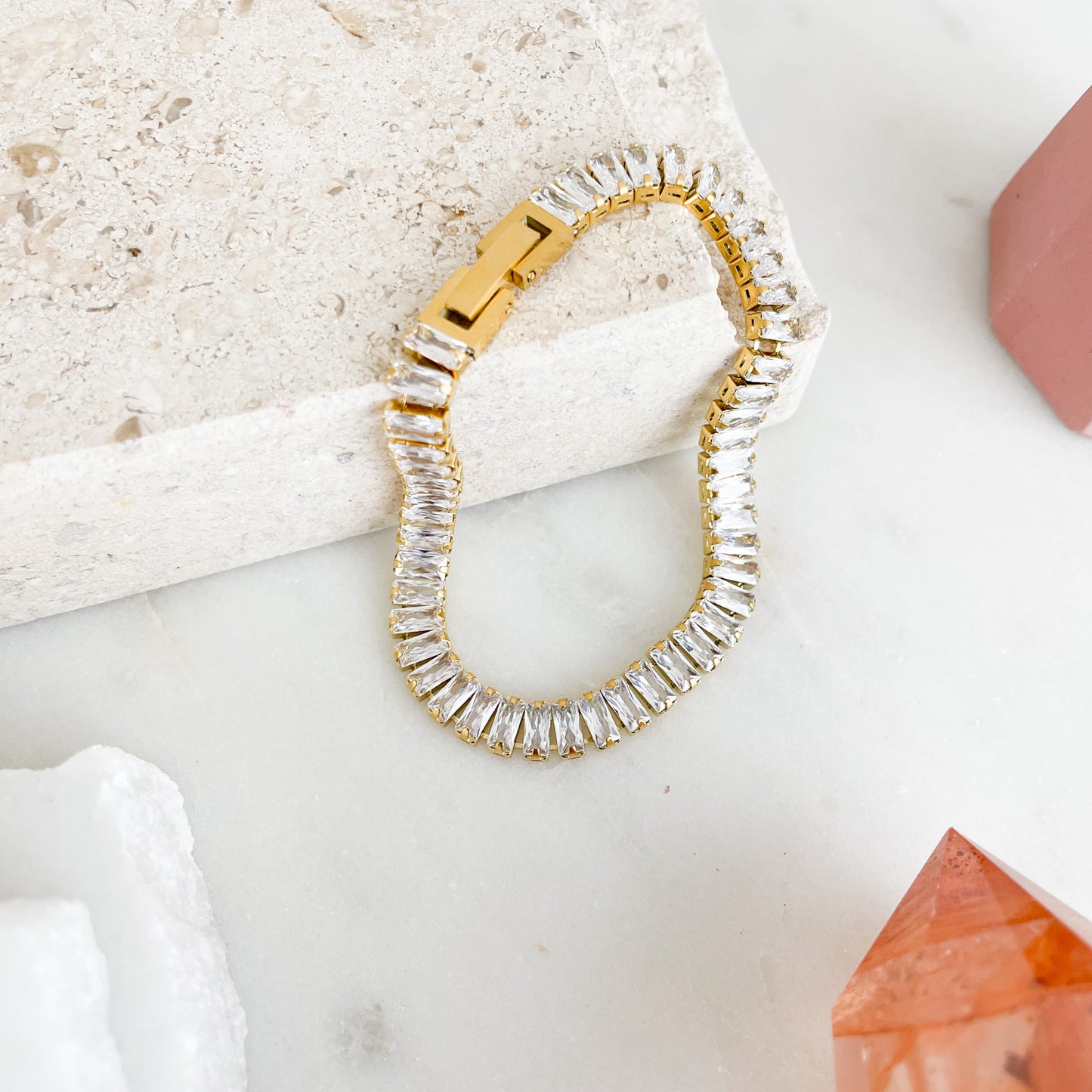 Baguette-cut cubic zirconia brings glamorous sparkle to an elegant tennis bracelet finished in 18K PVD Gold Plated
